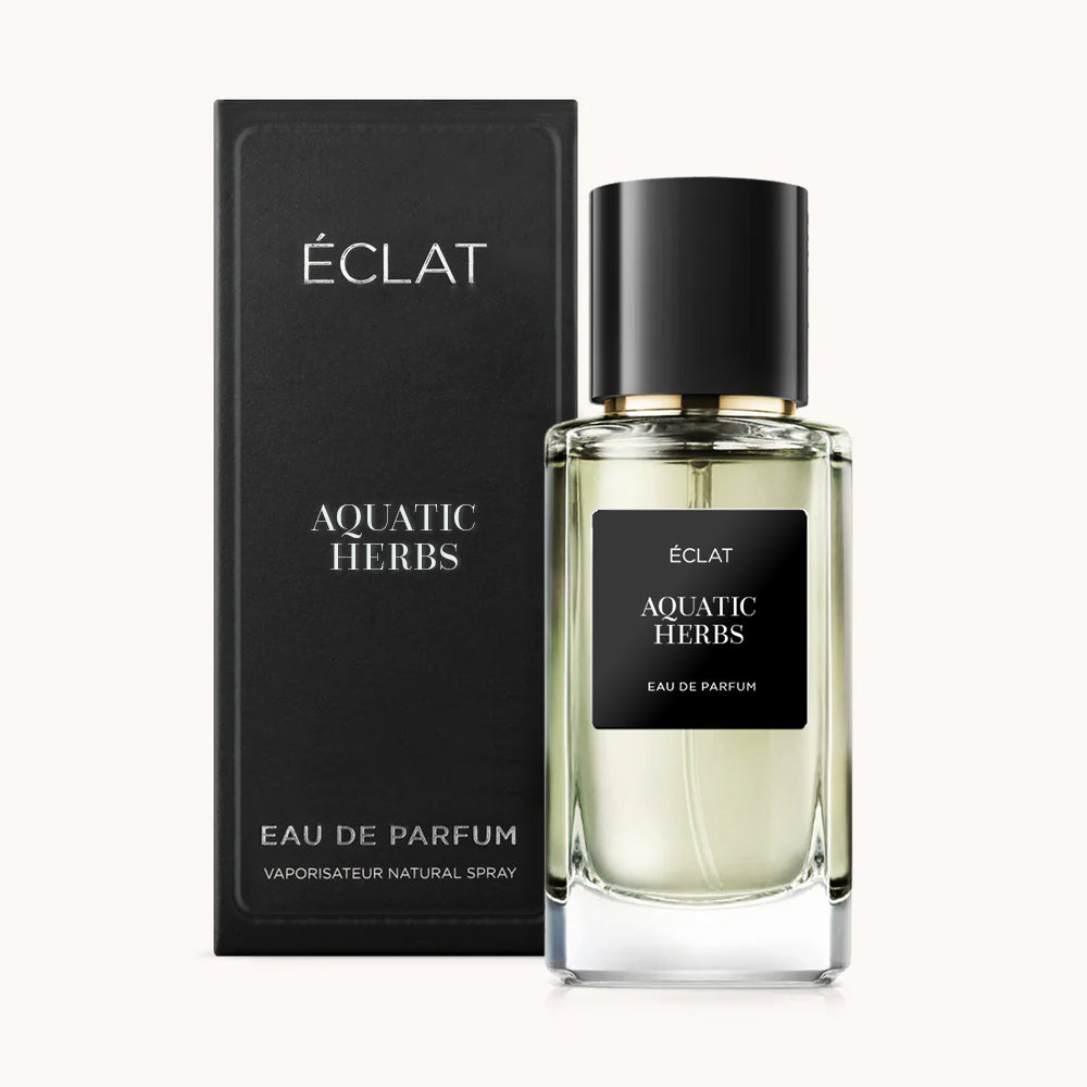 ÉCLAT Aquatic Herbs men's perfume bottle with matching black packaging. The elegant flacon features a black cylindrical magnetic cap and a black label with the inscription ÉCLAT Aquatic Herbs and “Eau de Parfum”.