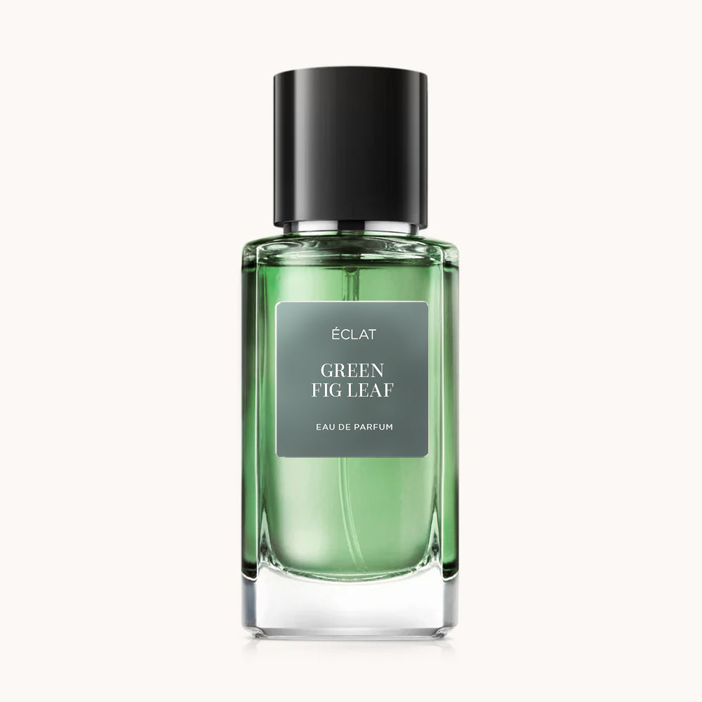 Flacon of the men's perfume dupe ÉCLAT Green Fig Leaf, an elegant transparent glass bottle with a black cylindrical magnetic cap and a green label. The label displays the brand name ÉCLAT, the name Green Fig Leaf, and the phrase “Eau de Parfum”.