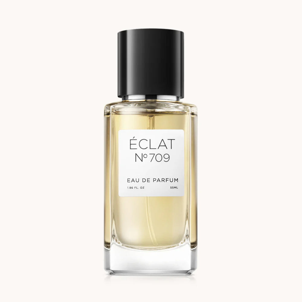 Flacon of the men’s perfume dupe ÉCLAT No. 709, an elegant transparent glass bottle with a black cylindrical magnetic cap and a minimalist white label. The label displays the brand name ÉCLAT, the number 709, and the phrase “Eau de Parfum”.