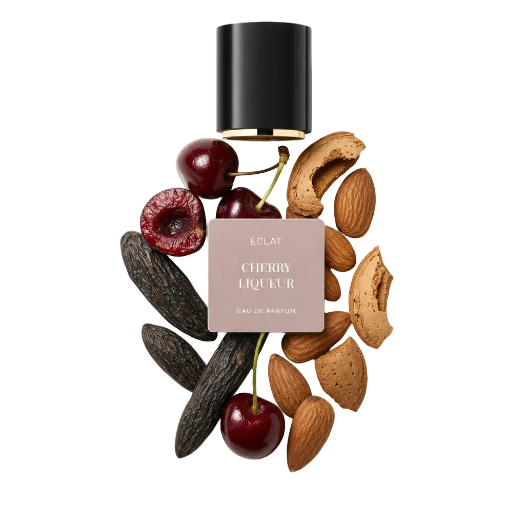 Una natura morta accuratamente disposta di ciliegie, bacche di vaniglia, mandorle e gusci circonda un tappo nero con etichetta ÉCLAT Cherry Liqueur.