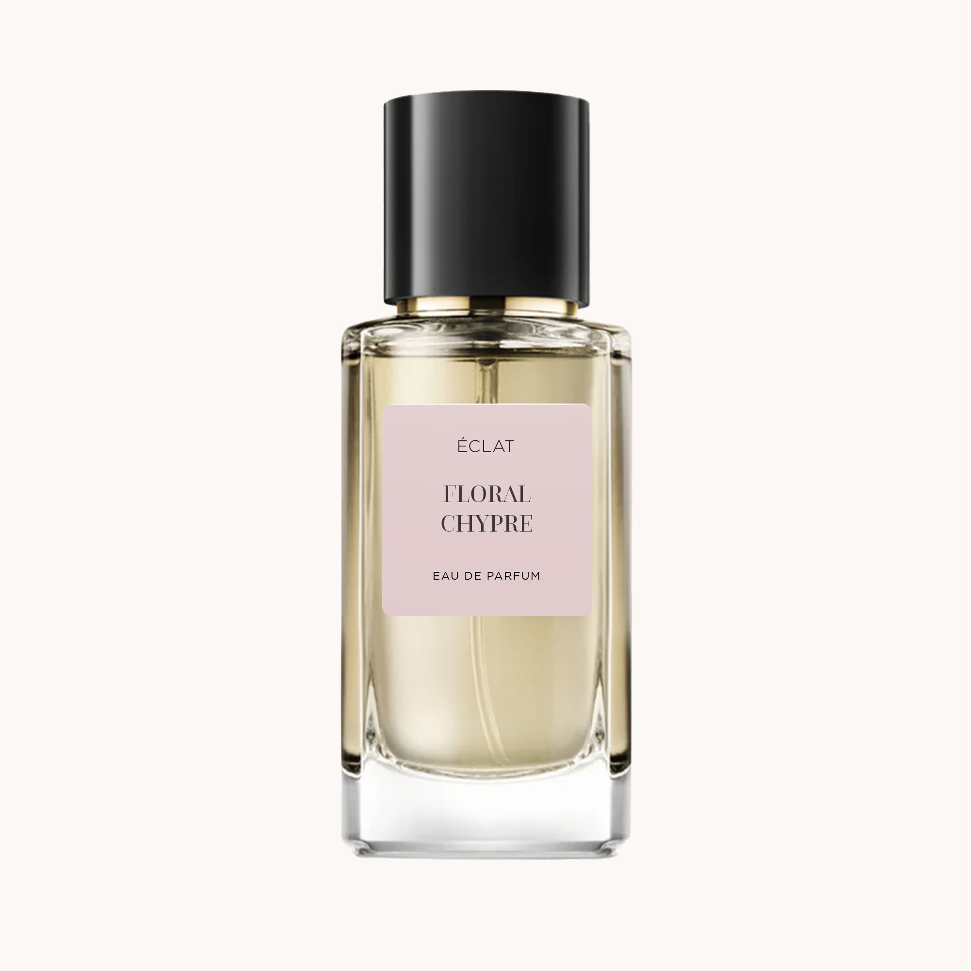 La bottiglia del profumo ÉCLAT Floral Chypre presenta un design in vetro trasparente con un'etichetta rosa pallido e un elegante tappo nero.