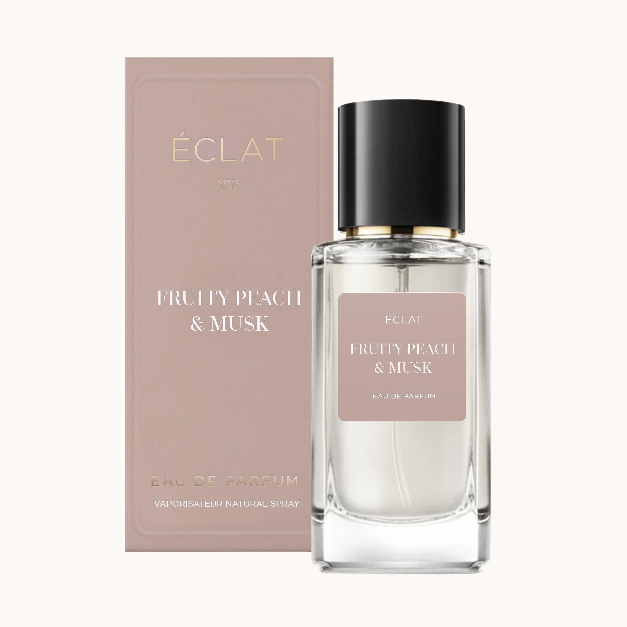 Una bottiglia di vetro trasparente di ÉCLAT Fruity Peach & Musk con tappo nero, accanto a una scatola rosa tenue.