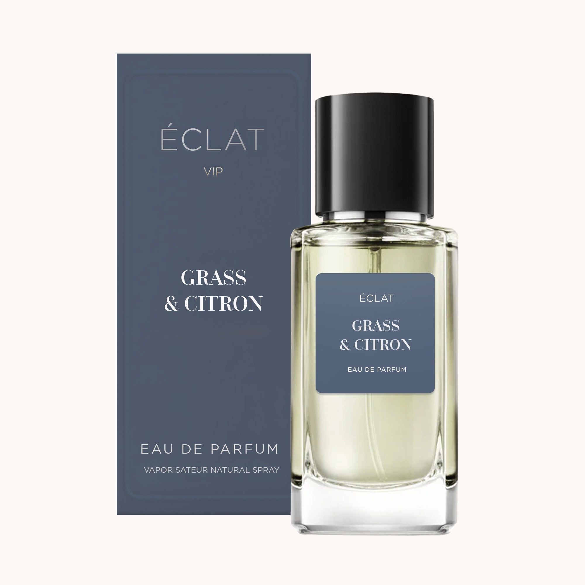 Flacone in vetro sfaccettato di ÉCLAT Grass & Citron con etichetta blu, accanto a una scatola blu coordinata.