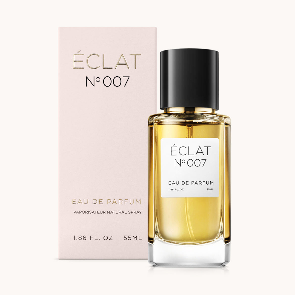 Profumo ÉCLAT Oriental Cloves con flacone in vetro trasparente e tappo nero, accanto a una scatola rosa con lettere dorate.