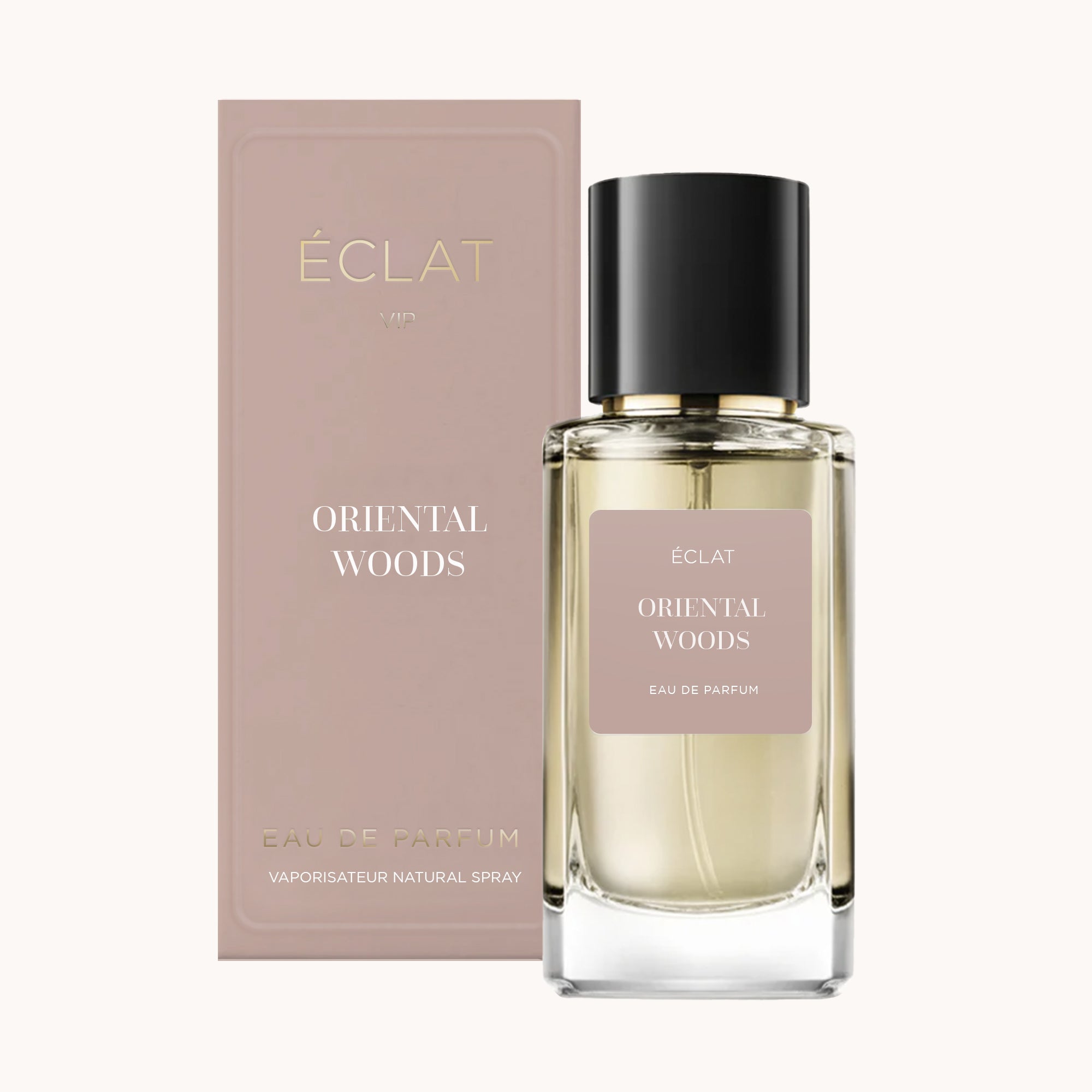 Flacone di profumo ÉCLAT Oriental Woods con tappo nero ed etichetta beige, accanto alla sua scatola beige coordinata.