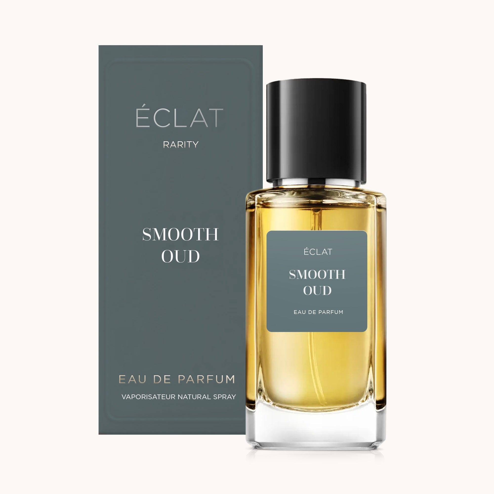 La bottiglia di profumo ÉCLAT Smooth Oud con tappo nero, accompagnata dalla sua elegante scatola grigia.