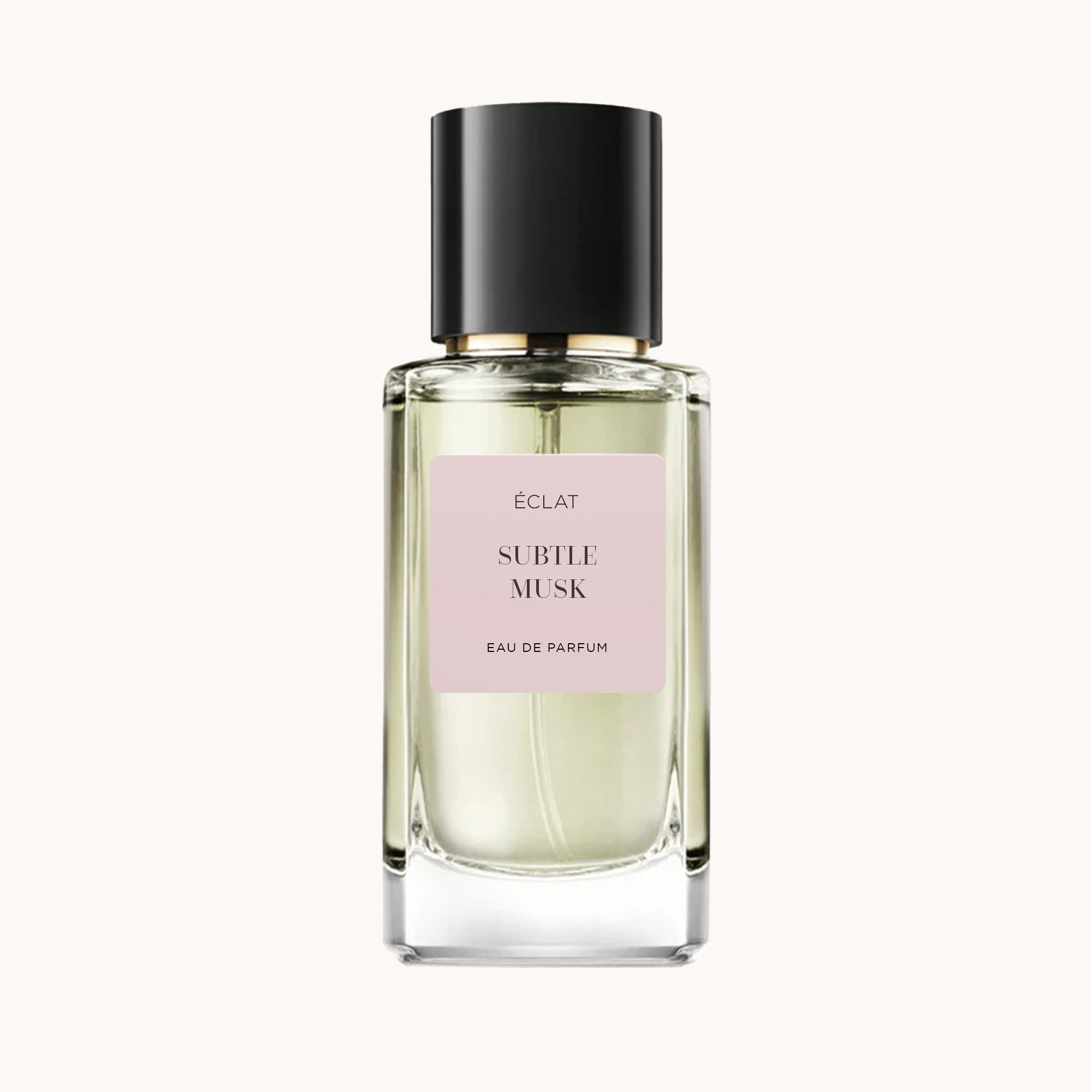 ÉCLAT Subtle Musk in un flacone di vetro sfaccettato trasparente con tappo nero e etichetta rosa tenue.