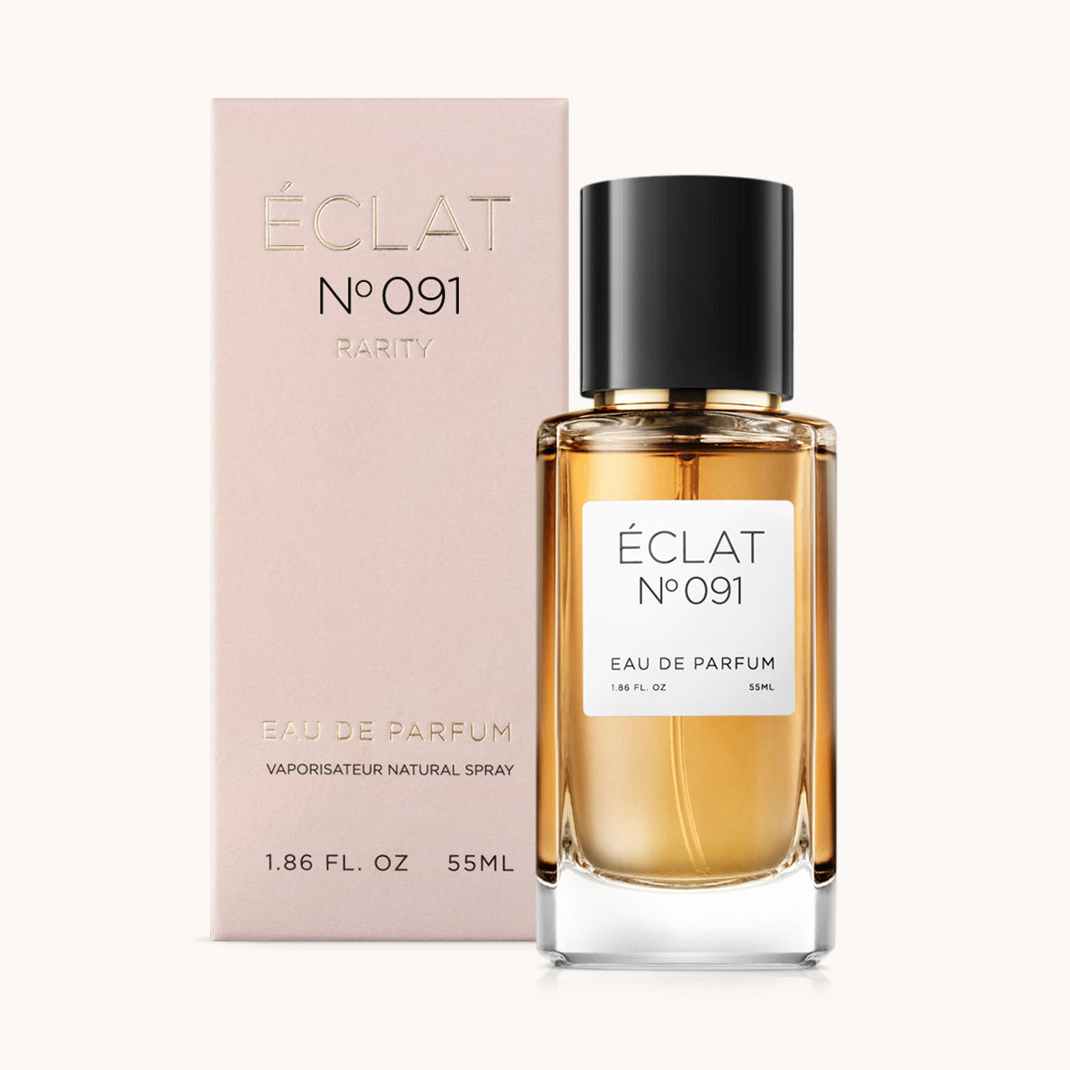 Flacone di profumo ÉCLAT Sweet Amaretto con tappo nero e una scatola rosa pallido accanto.
