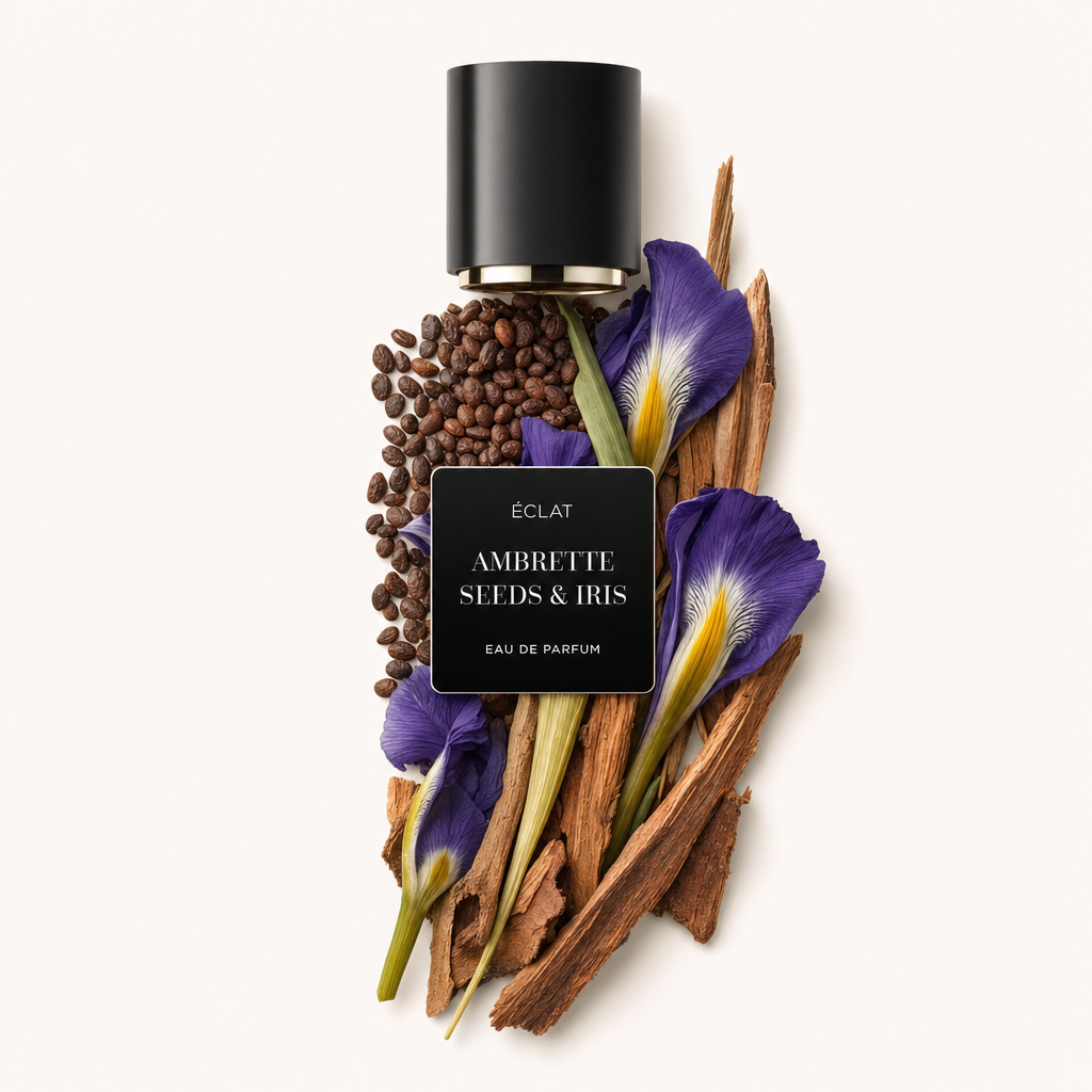 Un arrangiamento di semi di ambretta, fiori di iris ed elementi in legno con un cappuccio nero etichettato 'ÉCLAT Ambrette Seeds & Iris.'