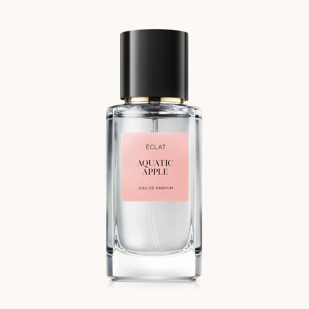 Bottiglia in vetro trasparente con tappo nero ed etichetta rosa pallido con ÉCLAT Aquatic Apple.
