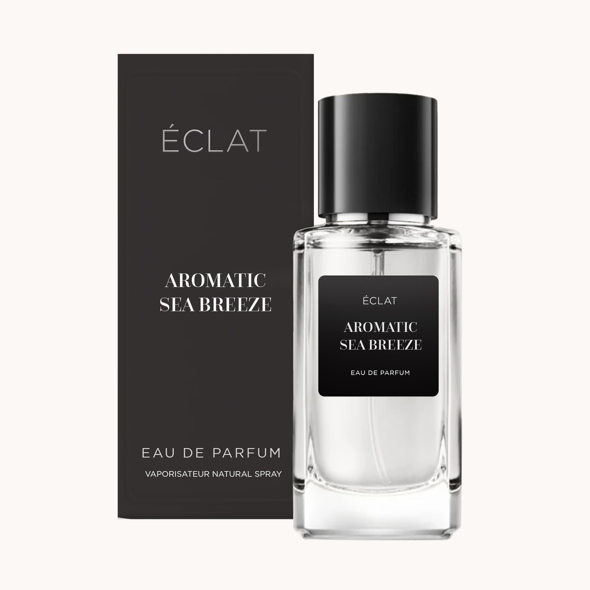 Flacone in vetro trasparente con tappo e etichetta neri, accanto a una scatola nera coordinata, mostra ÉCLAT Aromatic Sea Breeze.