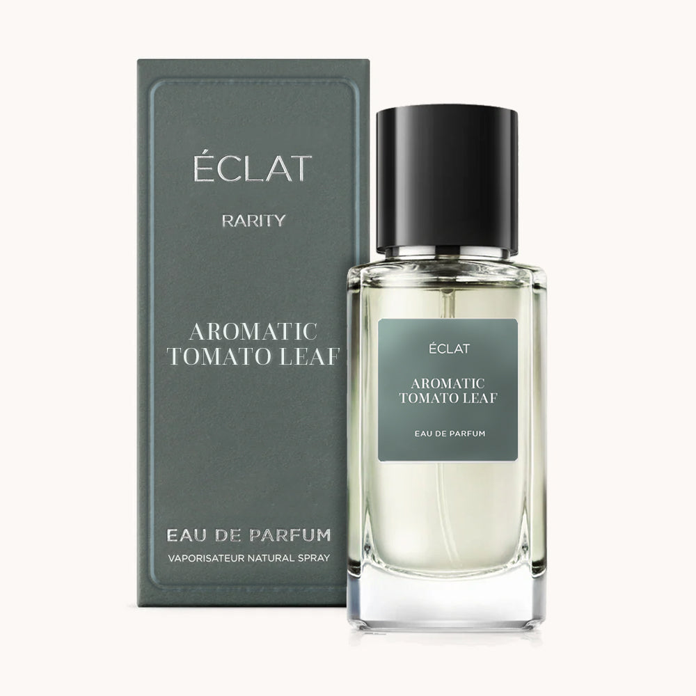 Flacone di profumo ÉCLAT Aromatic Tomato Leaf con etichetta verde scuro e tappo nero, accanto a scatola coordinata.