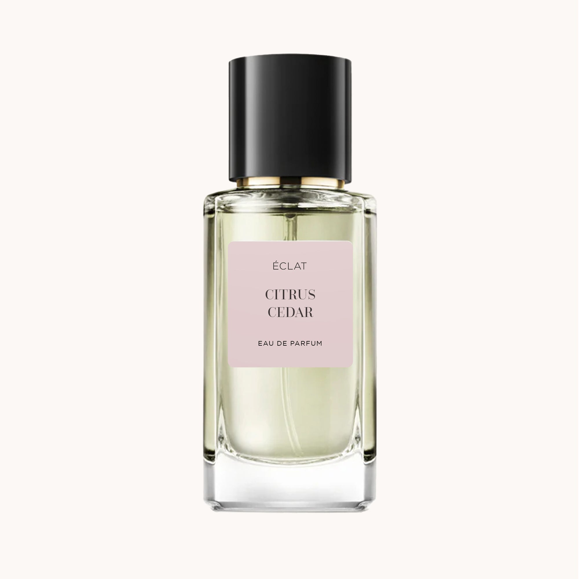 ÉCLAT Citrus Cedar in un flacone di vetro sfaccettato con tappo nero e etichetta pastello al centro.