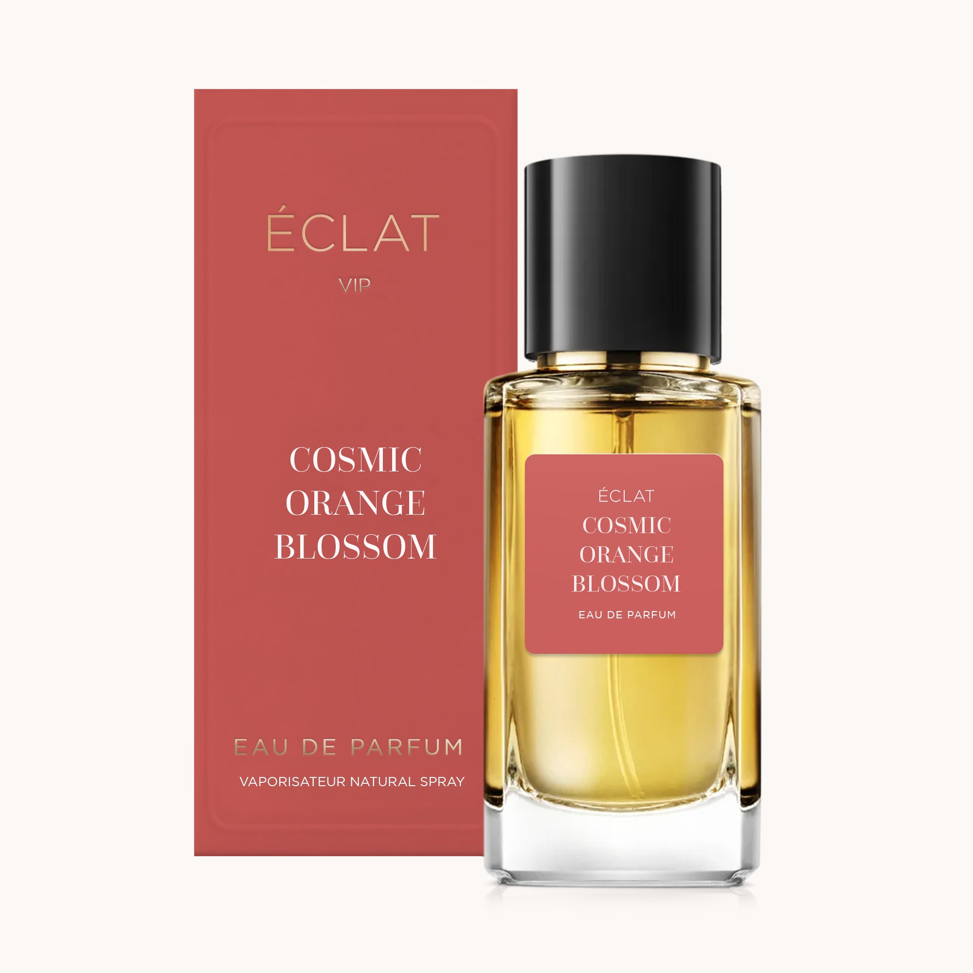Elegante flacone di vetro con tappo scuro accanto a una scatola coordinata, entrambi con etichetta ÉCLAT Cosmic Orange Blossom.