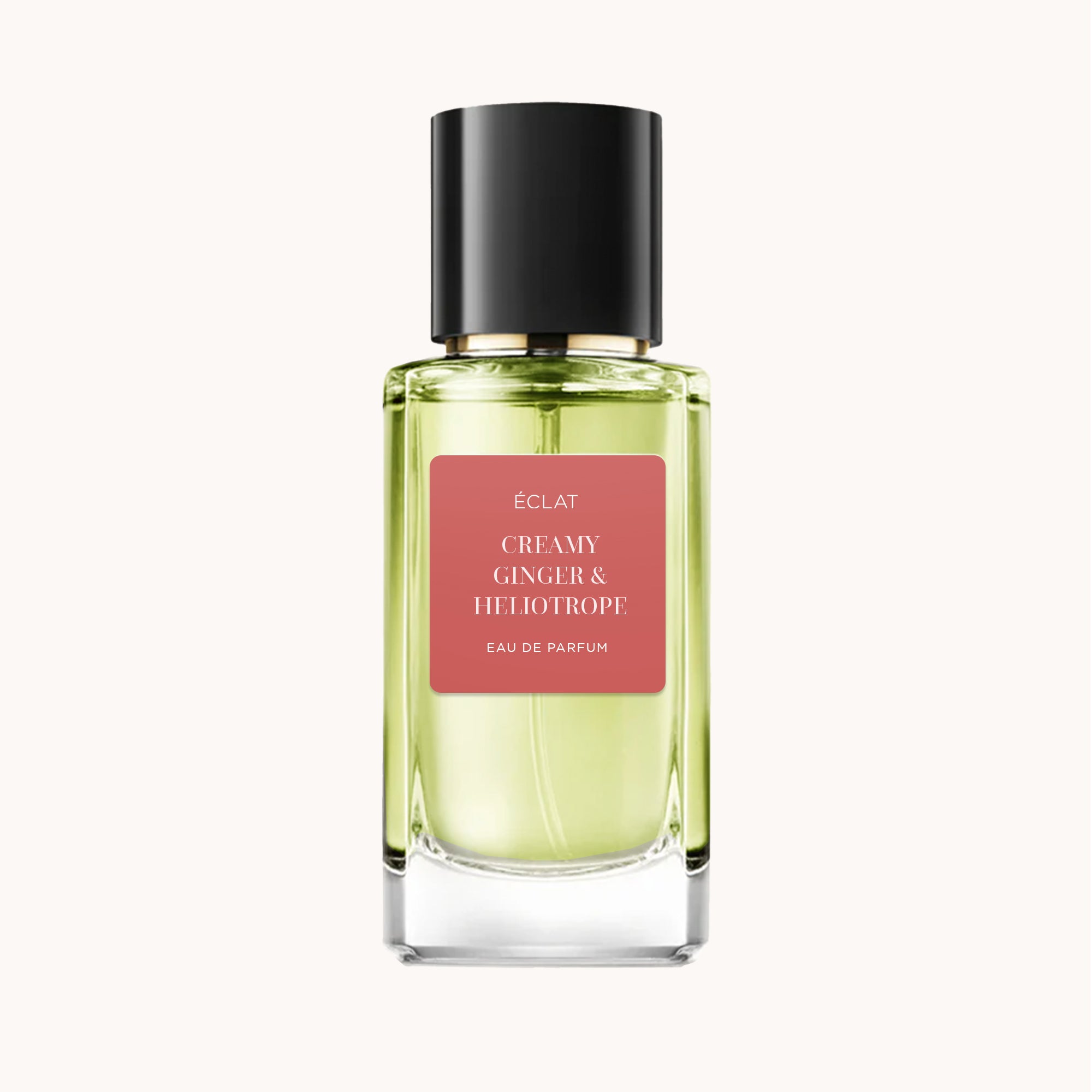 Un flacone in vetro sfaccettato di ÉCLAT Creamy Ginger & Heliotrope con tappo nero ed etichetta rosa.