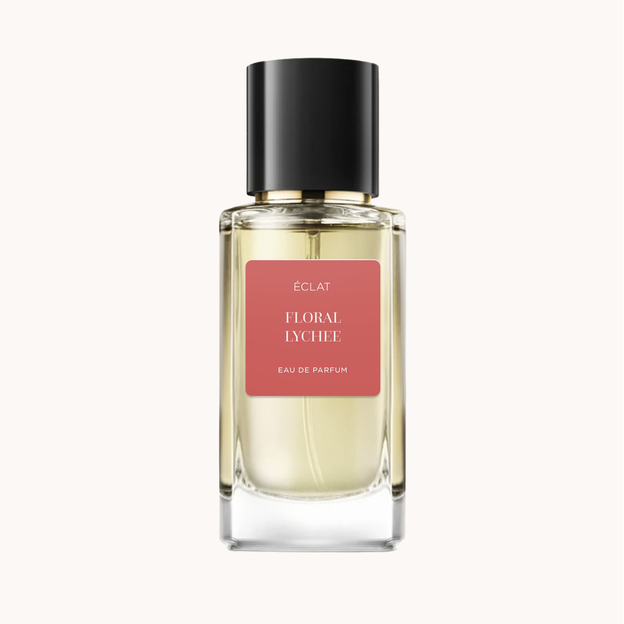Flacone di vetro sfaccettato con tappo nero, etichetta opaca in rosa caldo con il nome ÉCLAT Floral Lychee.