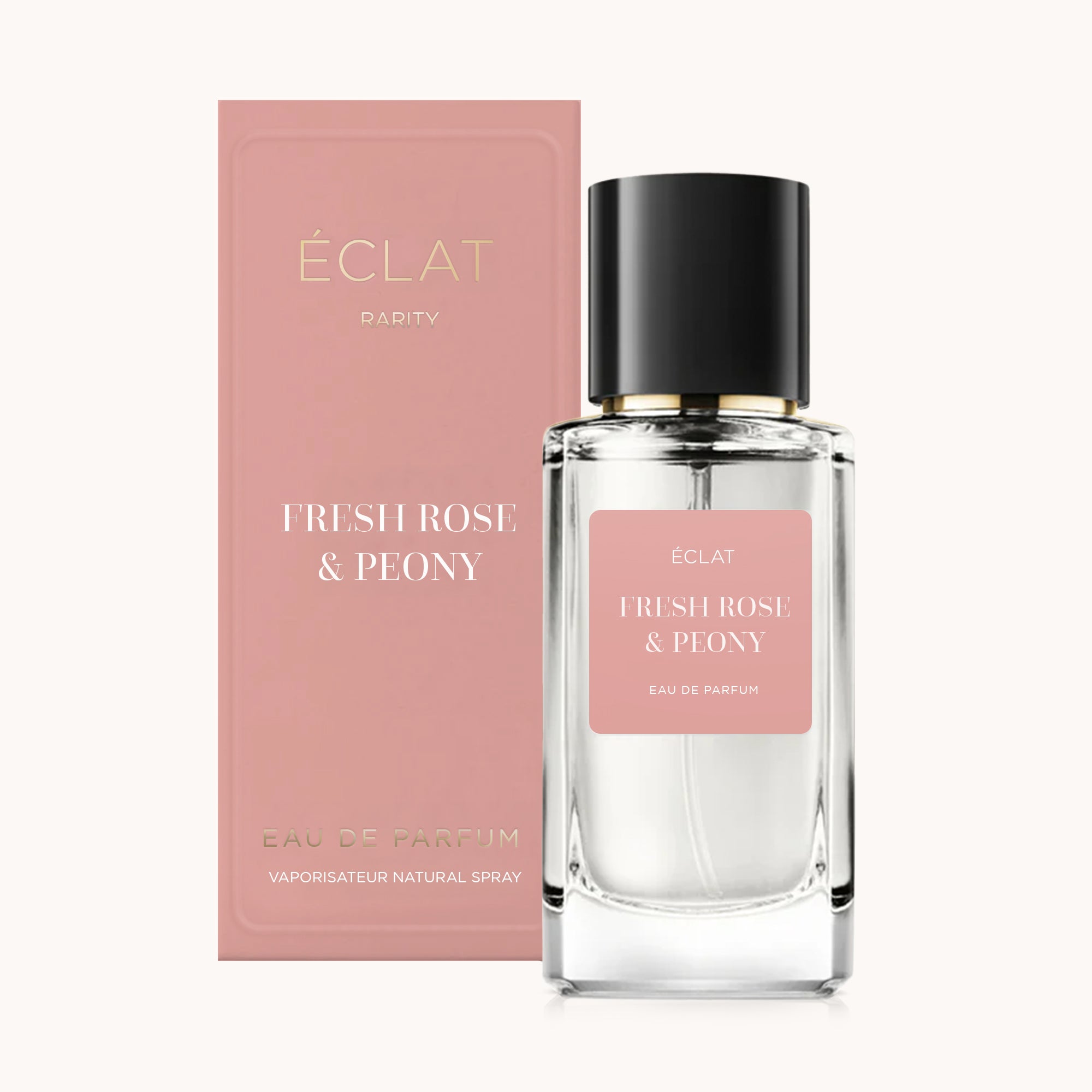 Flacone di profumo ÉCLAT Fresh Rose & Peony in vetro trasparente con tappo nero, accanto a una scatola rosa coordinata.