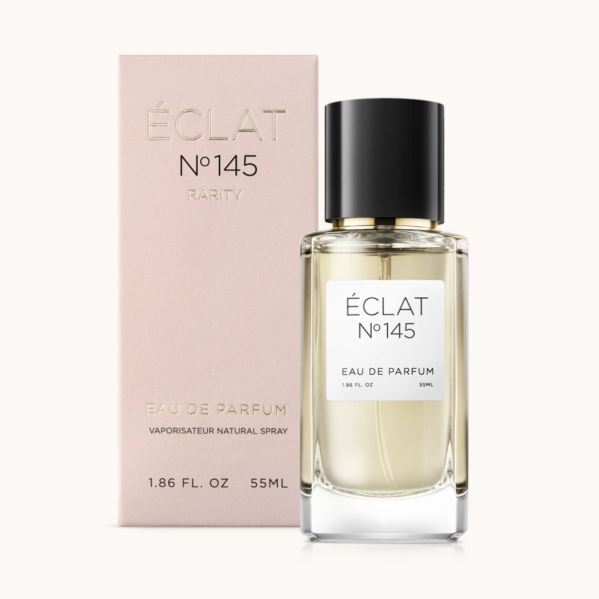 Flacone di vetro sfaccettato con tappo nero, accanto a una scatola rosa per ÉCLAT Ginger & Pear.