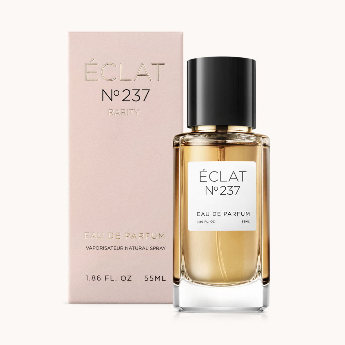 Bottiglia in vetro sfaccettato di ÉCLAT Iris Butter & Suede con tappo nero, accanto a una scatola rosa.