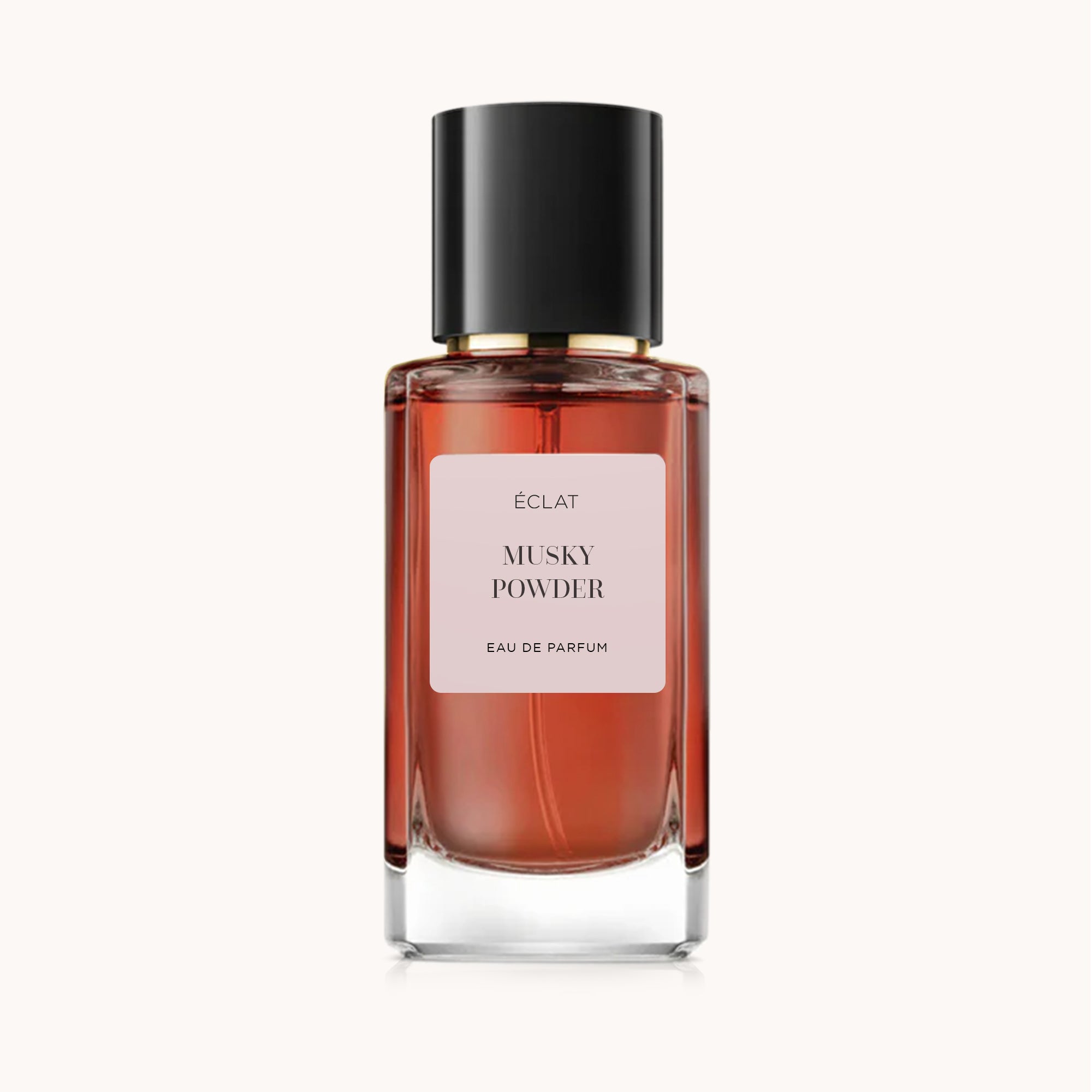 Bottiglia sfaccettata di ÉCLAT Musky Powder con tappo nero e etichetta rosa.