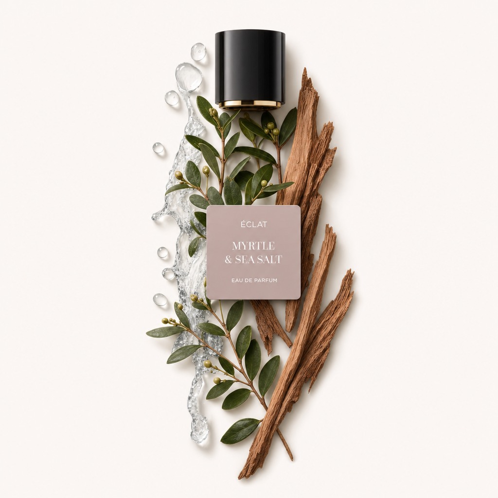 Un arrangiamento di rami di mirto con bacche, sale marino fluente e pezzi di legno accanto a un tappo nero con etichetta per ÉCLAT Myrtle & Sea Salt.