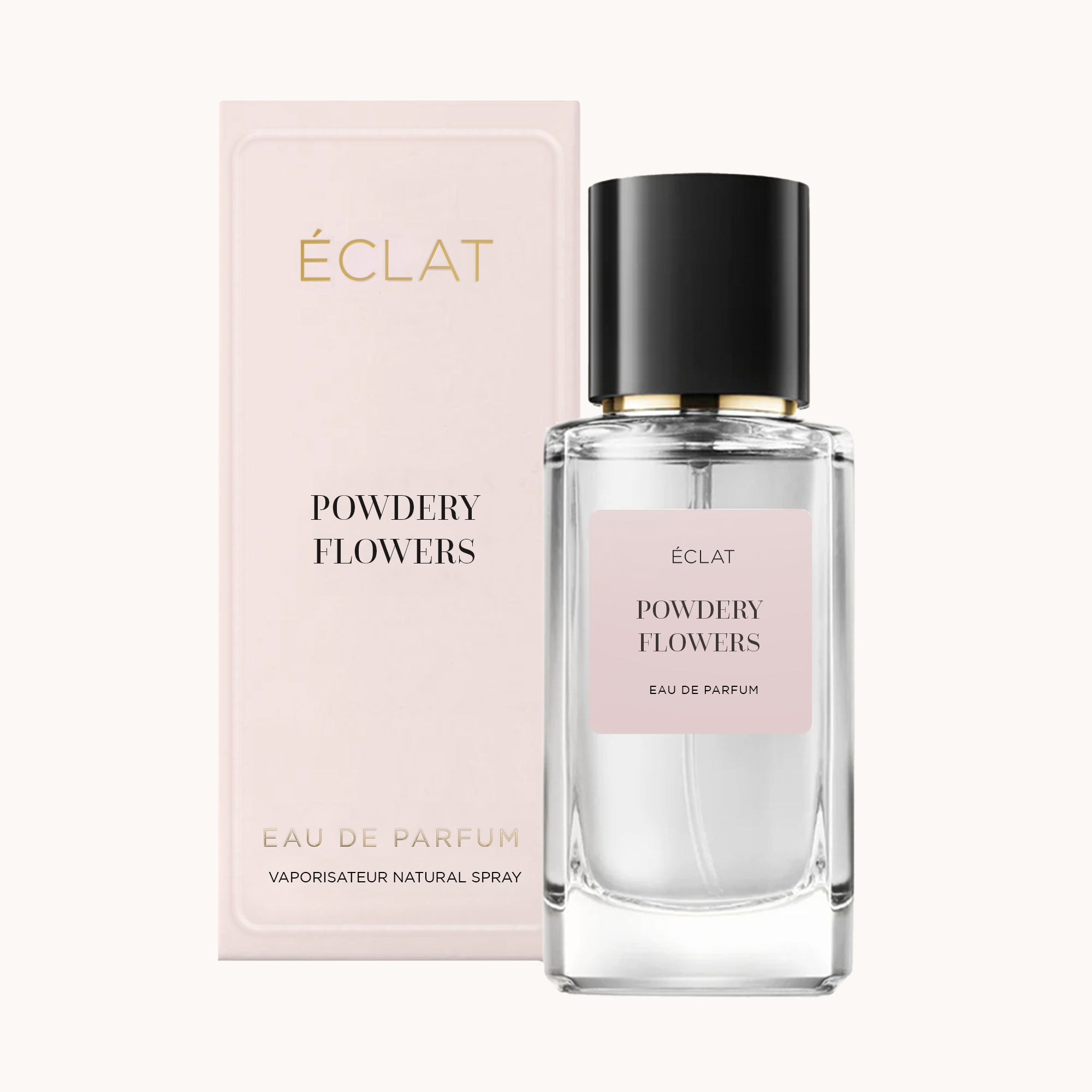 Flacone in vetro sfaccettato di ÉCLAT Powdery Flowers con tappo nero, accanto a una confezione rosa pallido.