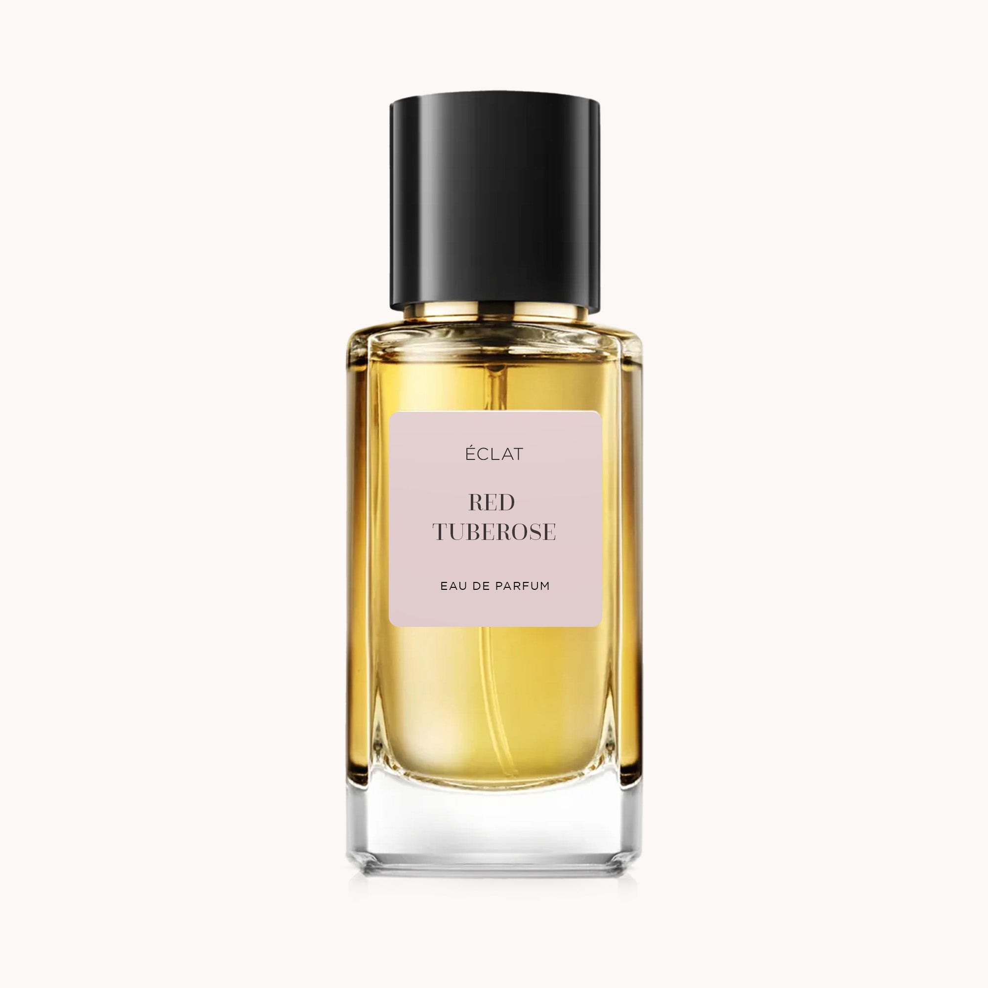 ÉCLAT Red Tuberose in un flacone di vetro sfaccettato con tappo nero elegante e etichetta rosa tenue.