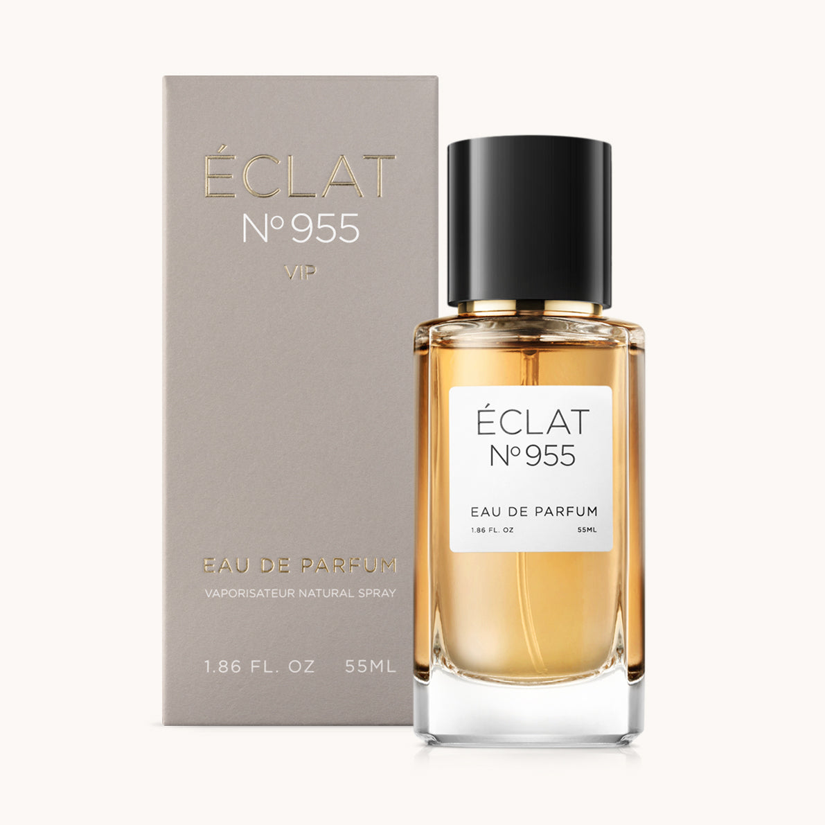 La fragranza ÉCLAT VIP Suede & Vanilla in un flacone di vetro trasparente con tappo nero, accompagnata dal suo elegante imballaggio grigio.