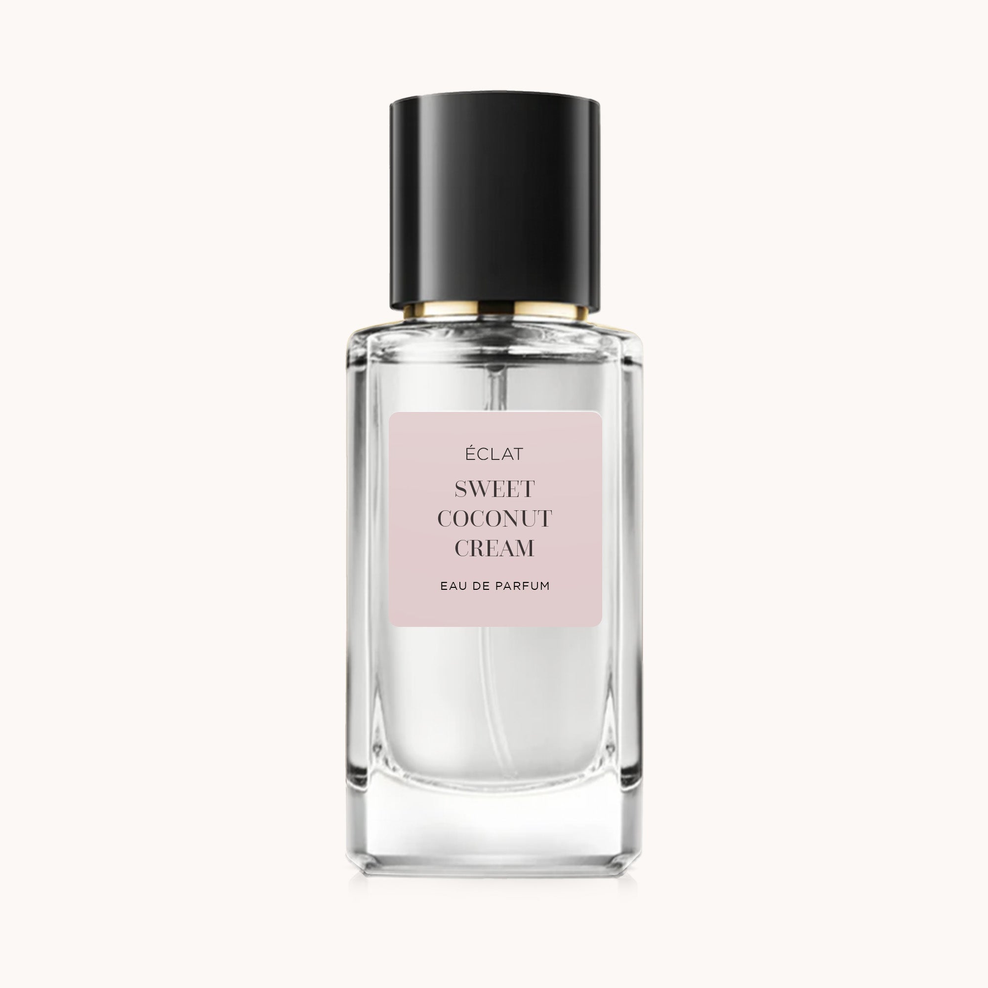 Flacone di vetro sfaccettato con tappo nero e etichetta rosa opaca, presenta ÉCLAT Sweet Coconut Cream.