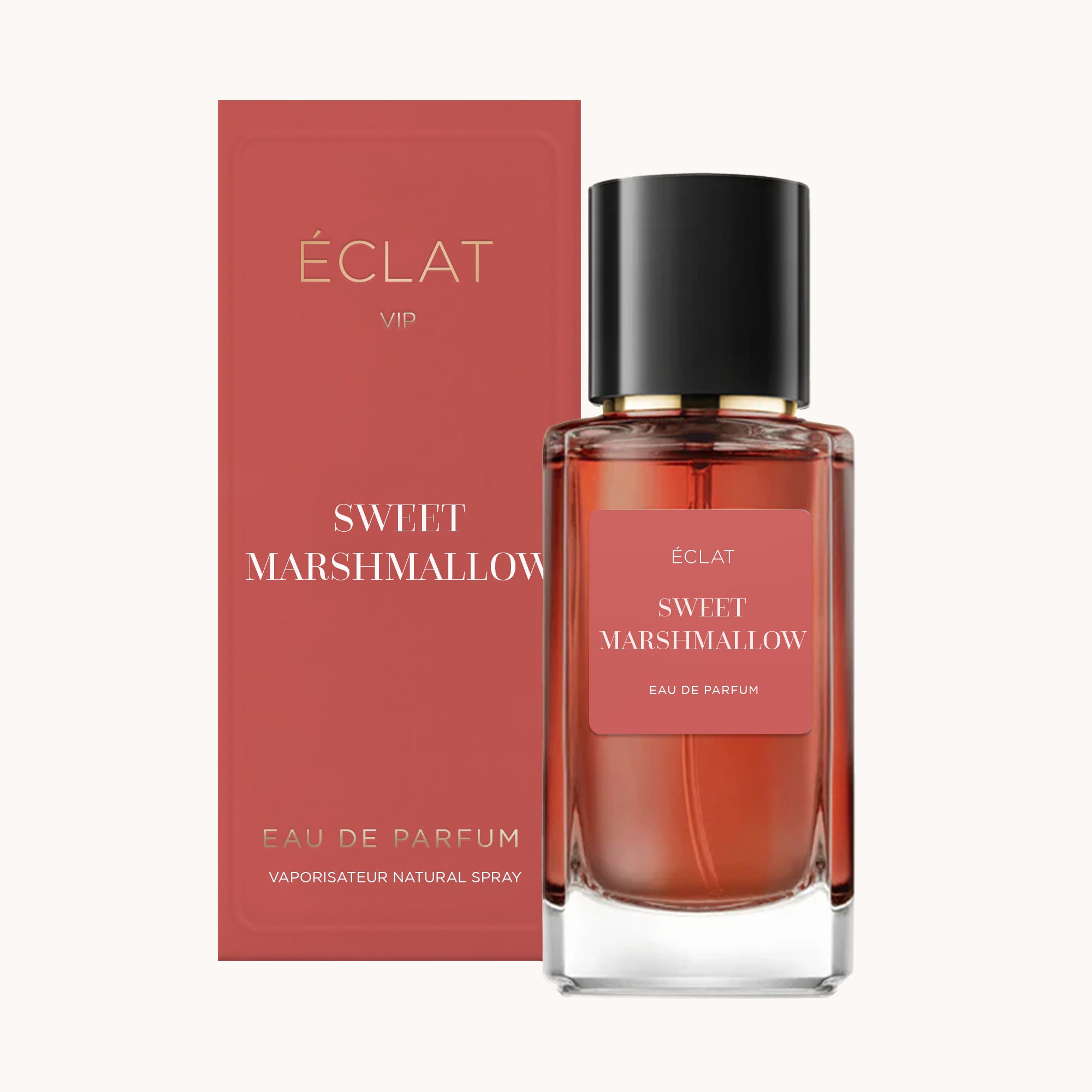 Flacone di profumo ÉCLAT Sweet Marshmallow in vetro trasparente con tappo nero, accanto alla scatola rosa abbinata.