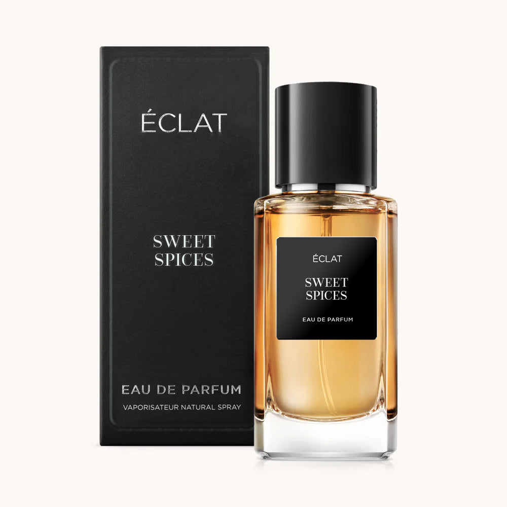 Profumo ÉCLAT Sweet Spices in un elegante flacone di vetro con tappo ed etichetta neri, accompagnato da una scatola nera coordinata.