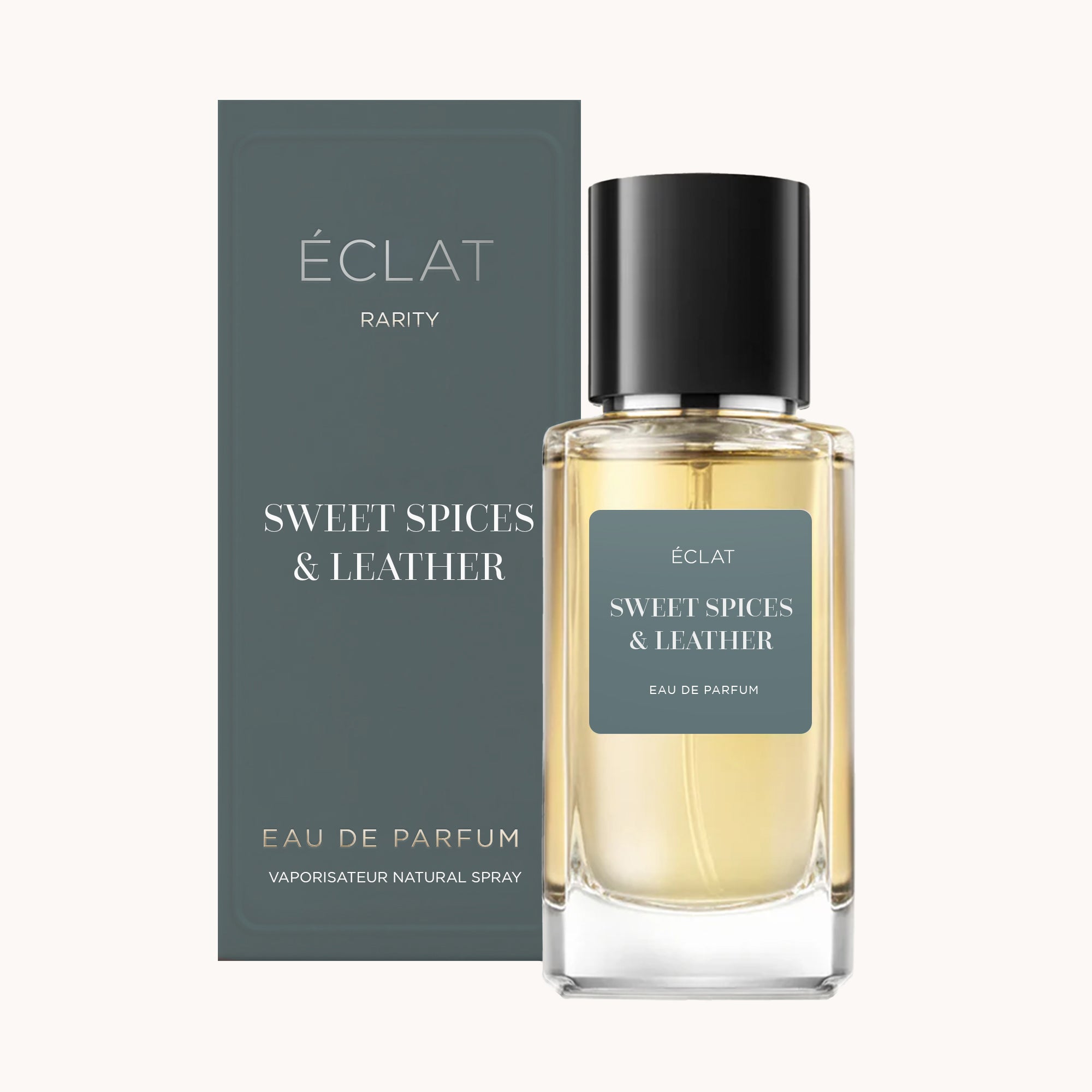 Boccetta ÉCLAT Sweet Spices & Leather con vetro trasparente e tappo nero, accanto a una scatola di confezione abbinata.